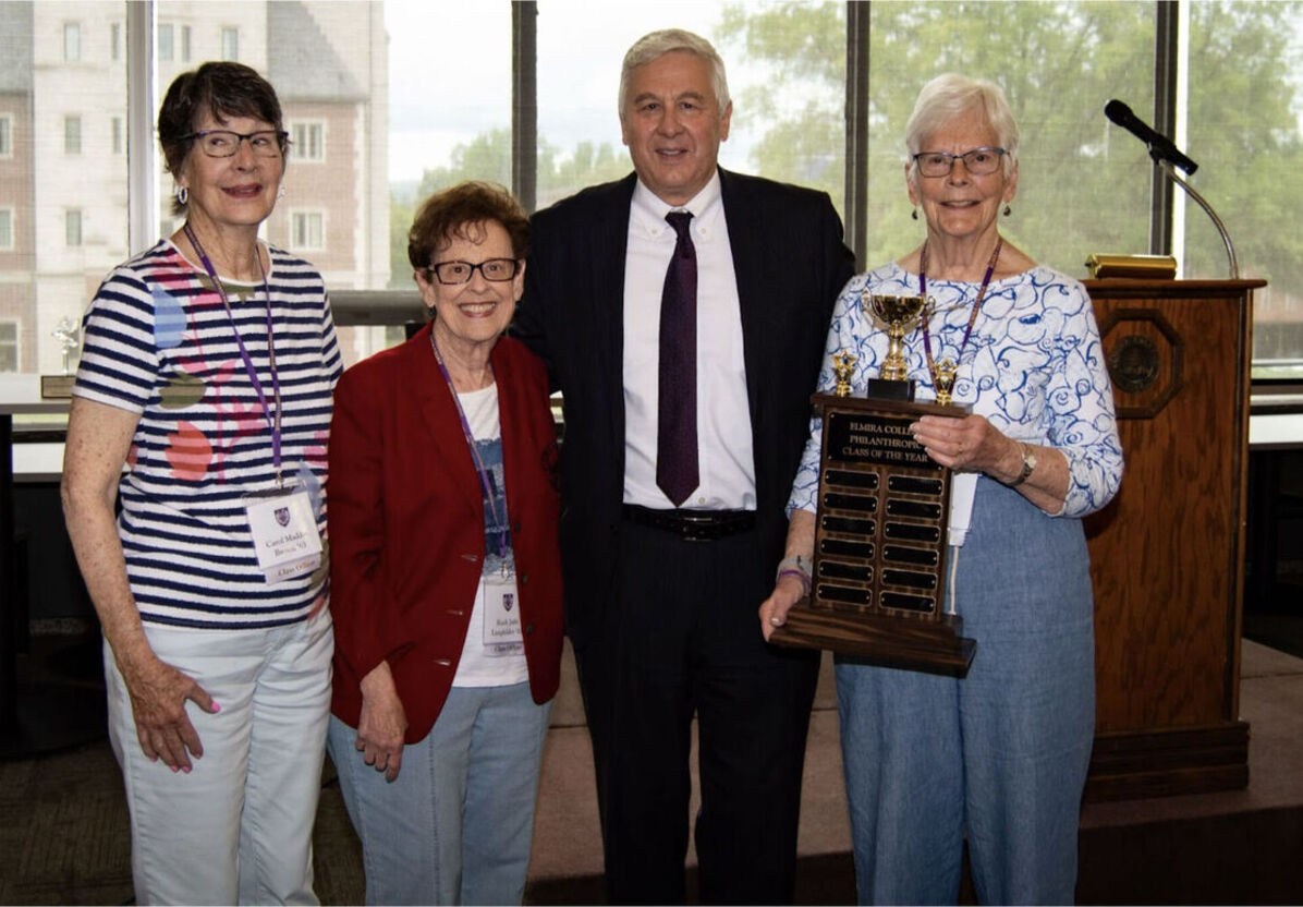 Three women from the Class of 1963 stand with President Lindsay while holding the Philanthropic Class of the Year award during the 2023 Reunion